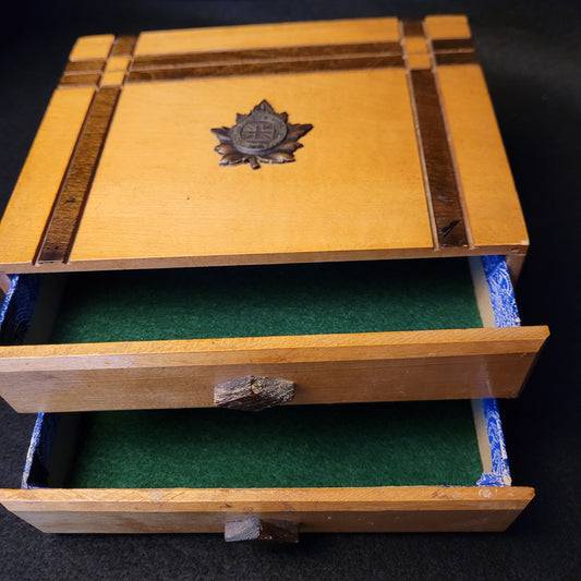 Wooden box with a decorative emblem on a dark background
